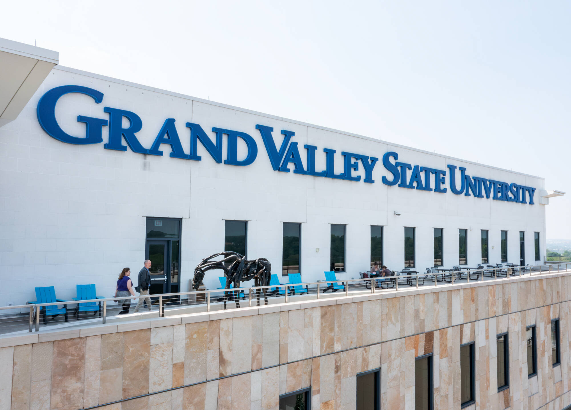 Art Museum learning and outreach manager Jessica Sundstrom and Art Museum curator of exhibitions and collections Joel Zwart look at “Char” on the fifth-floor terrace of the Daniel and Pamella DeVos Center for Interprofessional Health in downtown Gr...